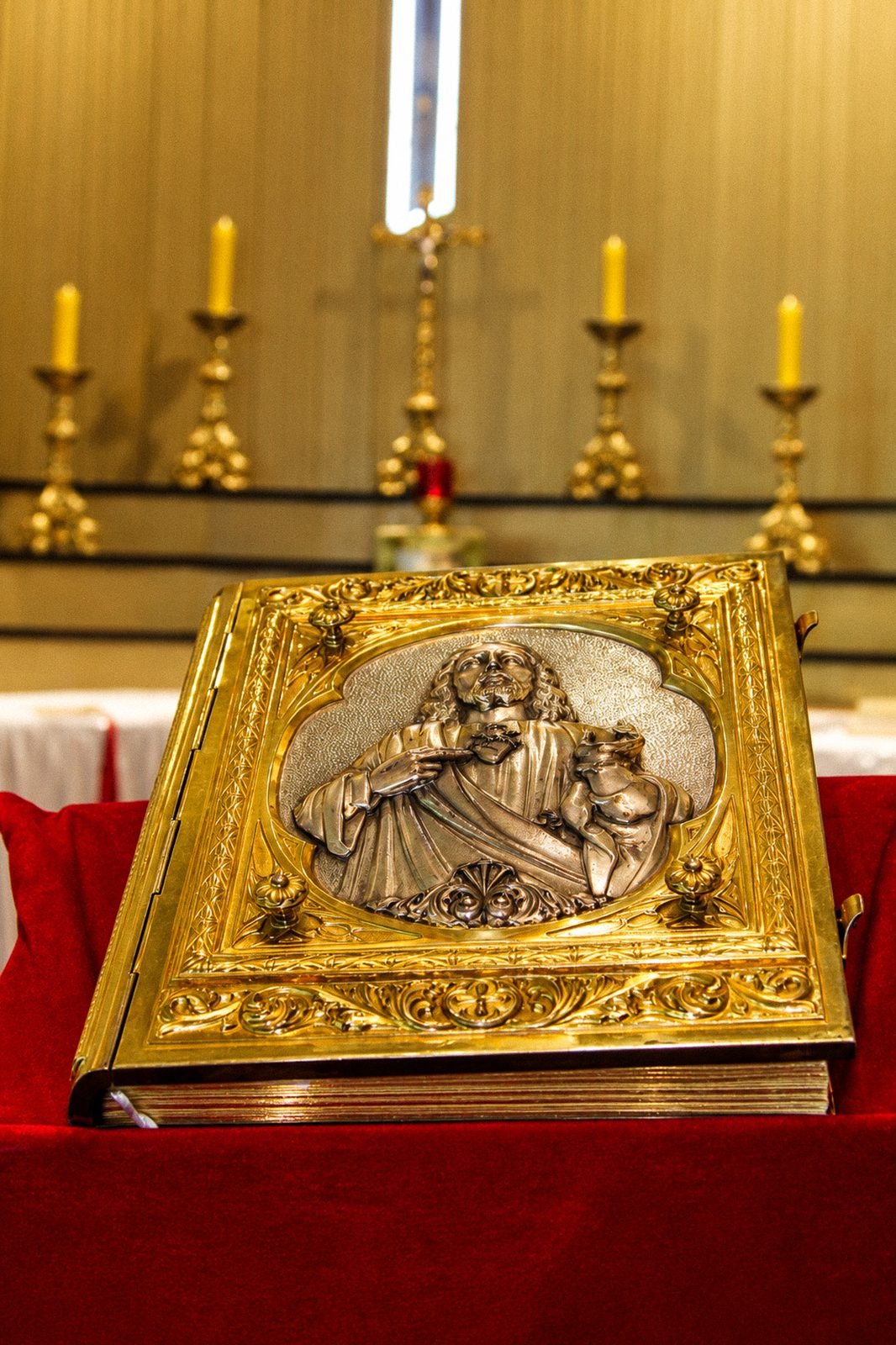 Evangeliário sobre o altar, com os castiçais ao fundo
